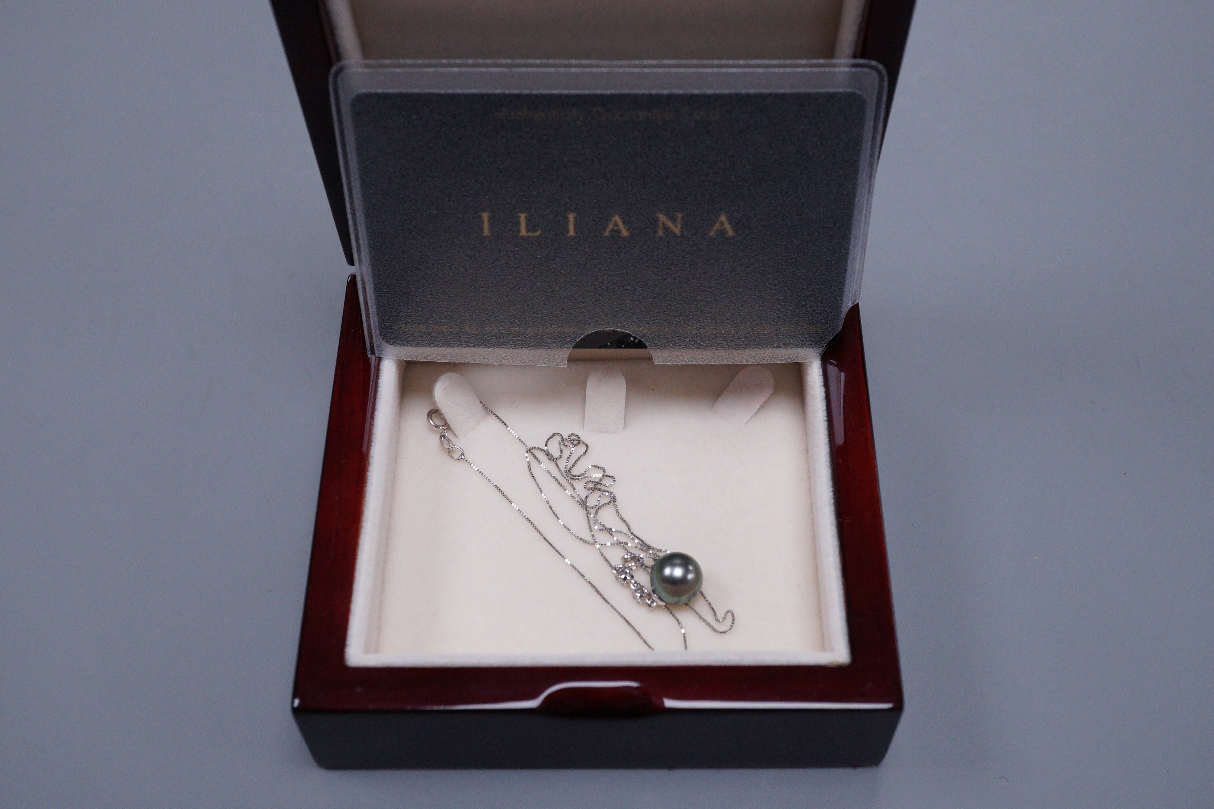 An Iliana 18ct white gold Tahitian pearl and diamond drop pendant, with original guarantee card and box